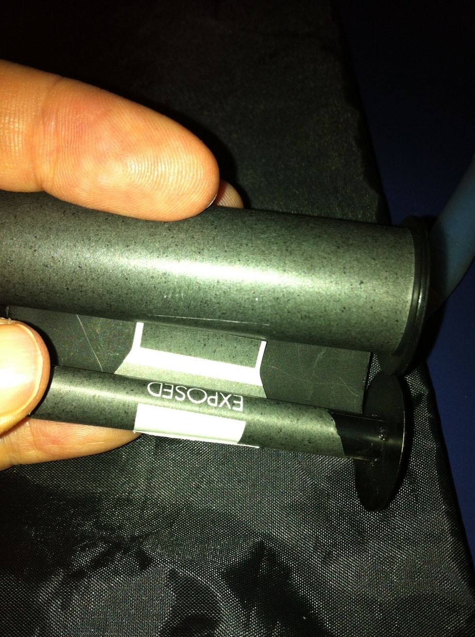 Tuck the tail and the sticker on to the new roll. Keep taught but not super tight.. Roll slowly now.. Feeling for the loose end of the film.. It's a way in