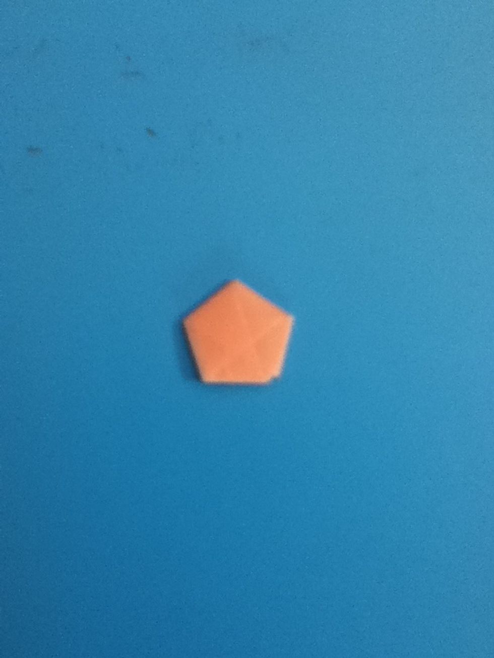 Tuck the tail into this pocket do that you end up with a neat little pentagon. Tucking into the pocket can be tricky, but don't give up!