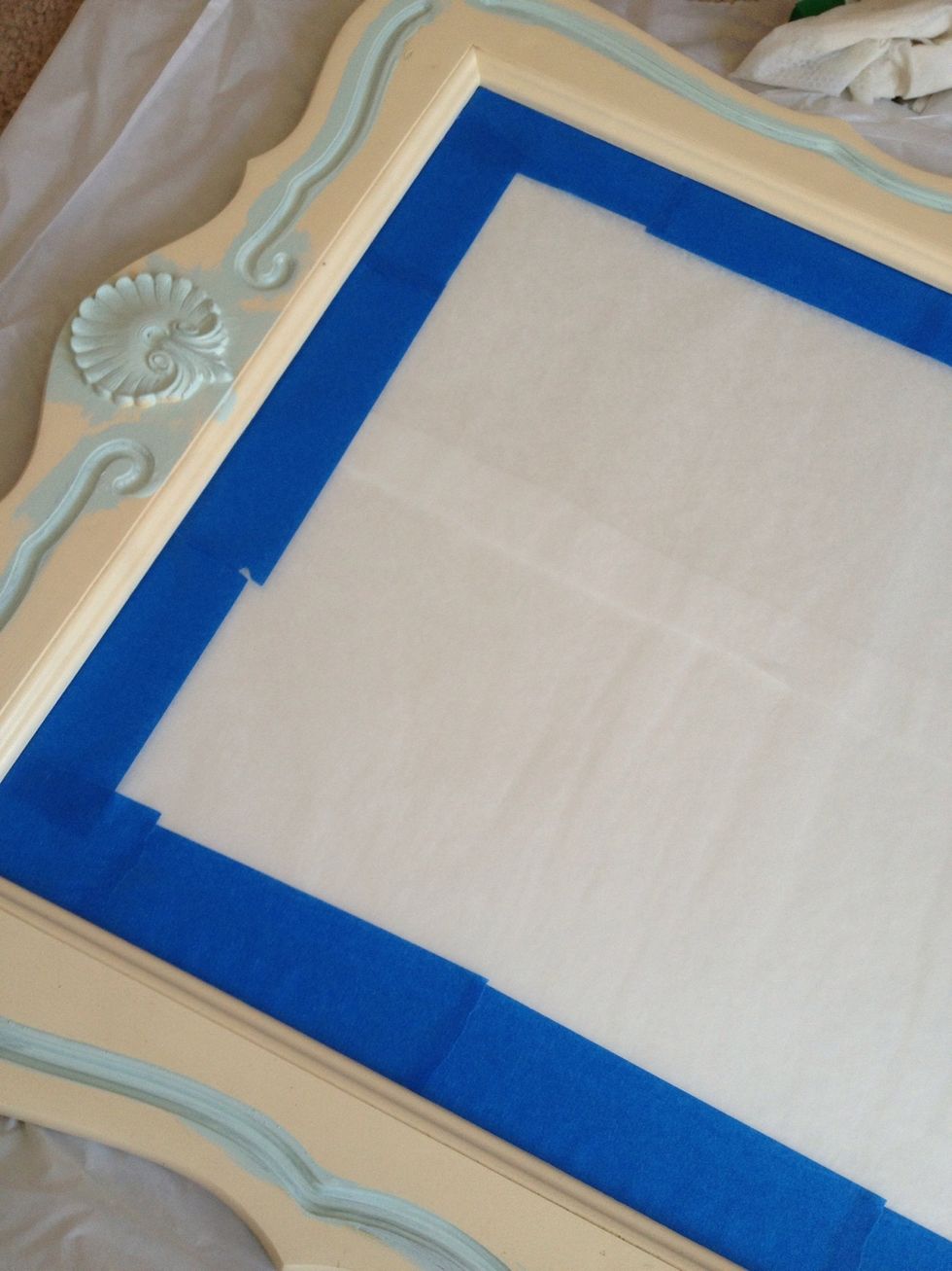 Tuck the tape under the lip of the wood if you can. Or put paper there and tape it. Use a razor blade to remove any paint or glue from tape later.