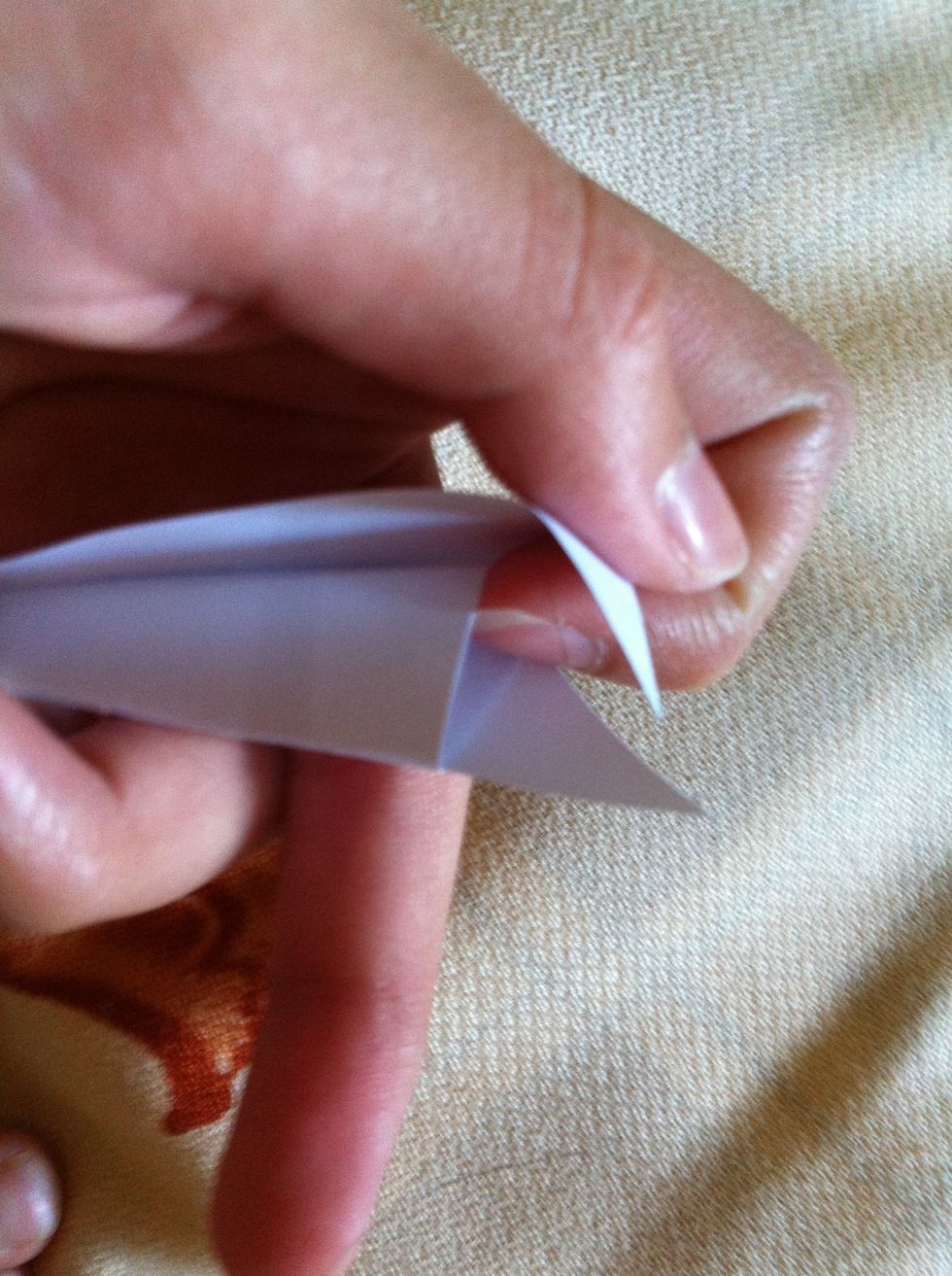 Tuck the top of the back into the pocket in front of it