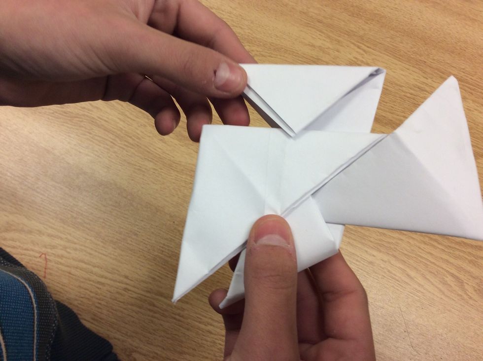 Tuck the two ends into the flaps as shown