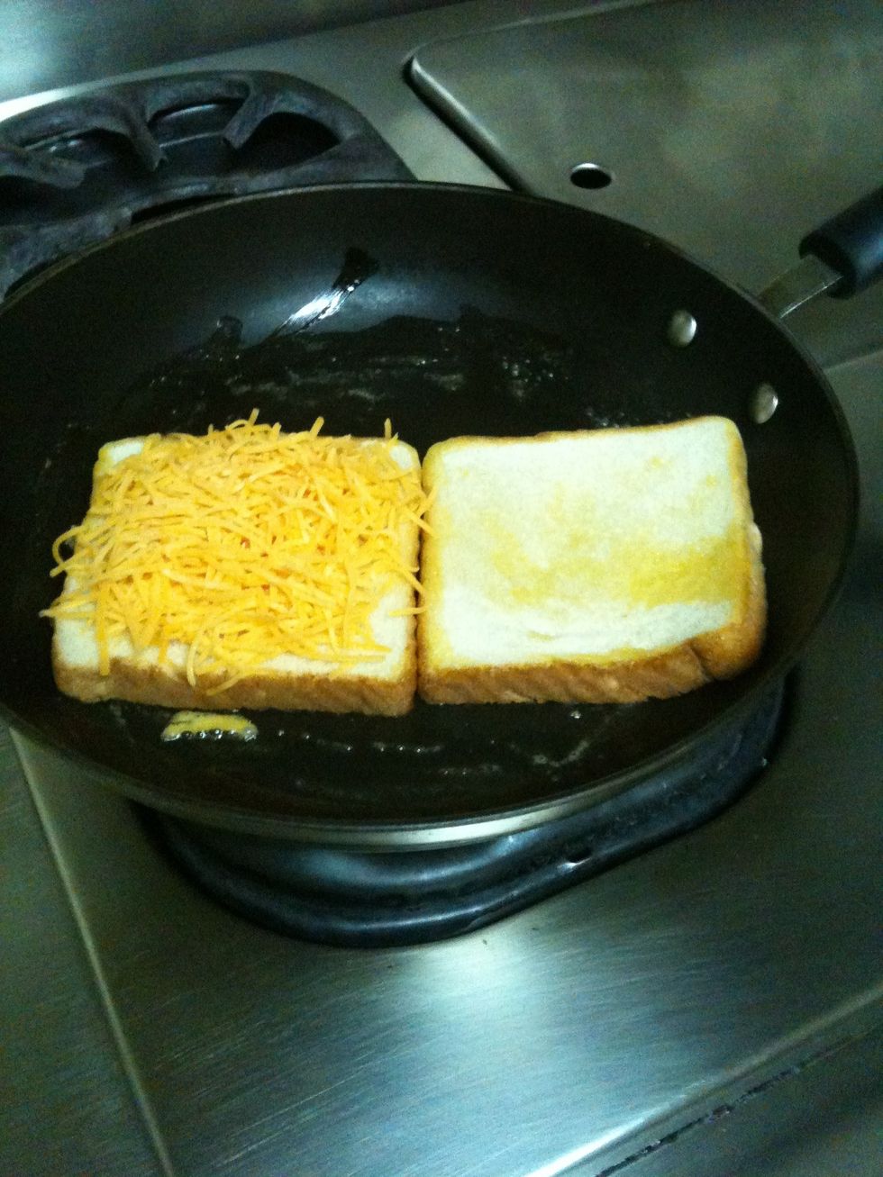Turn bread over and add cheddar cheese ( I like to add a lot a cheese, for when I cut in half it just melts out)