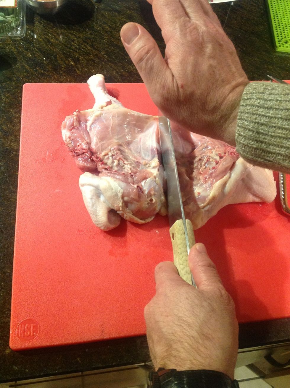 Turn chicken so wing are towards you use a large knife and split the breast bone with sharp rap from the palm of your hand. Not to hard cuts easily and you do not want to cut skin on bottom.