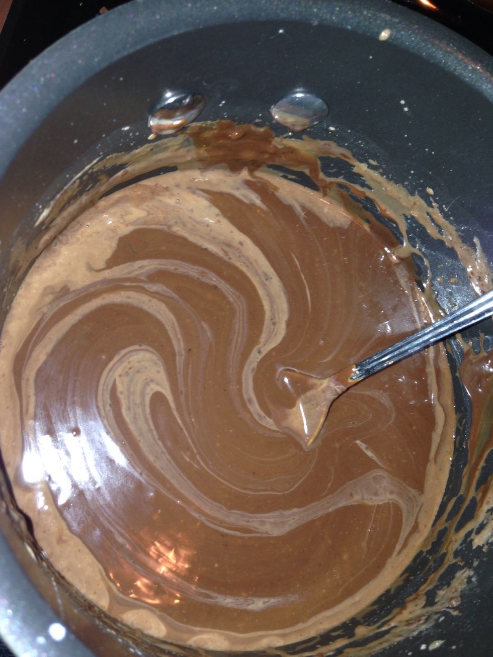 Turn down the burner when the chocolate is still lumpy and add some cream...don't pour it all in though, do it slowly so you get it smooth without thinning out the chocolate