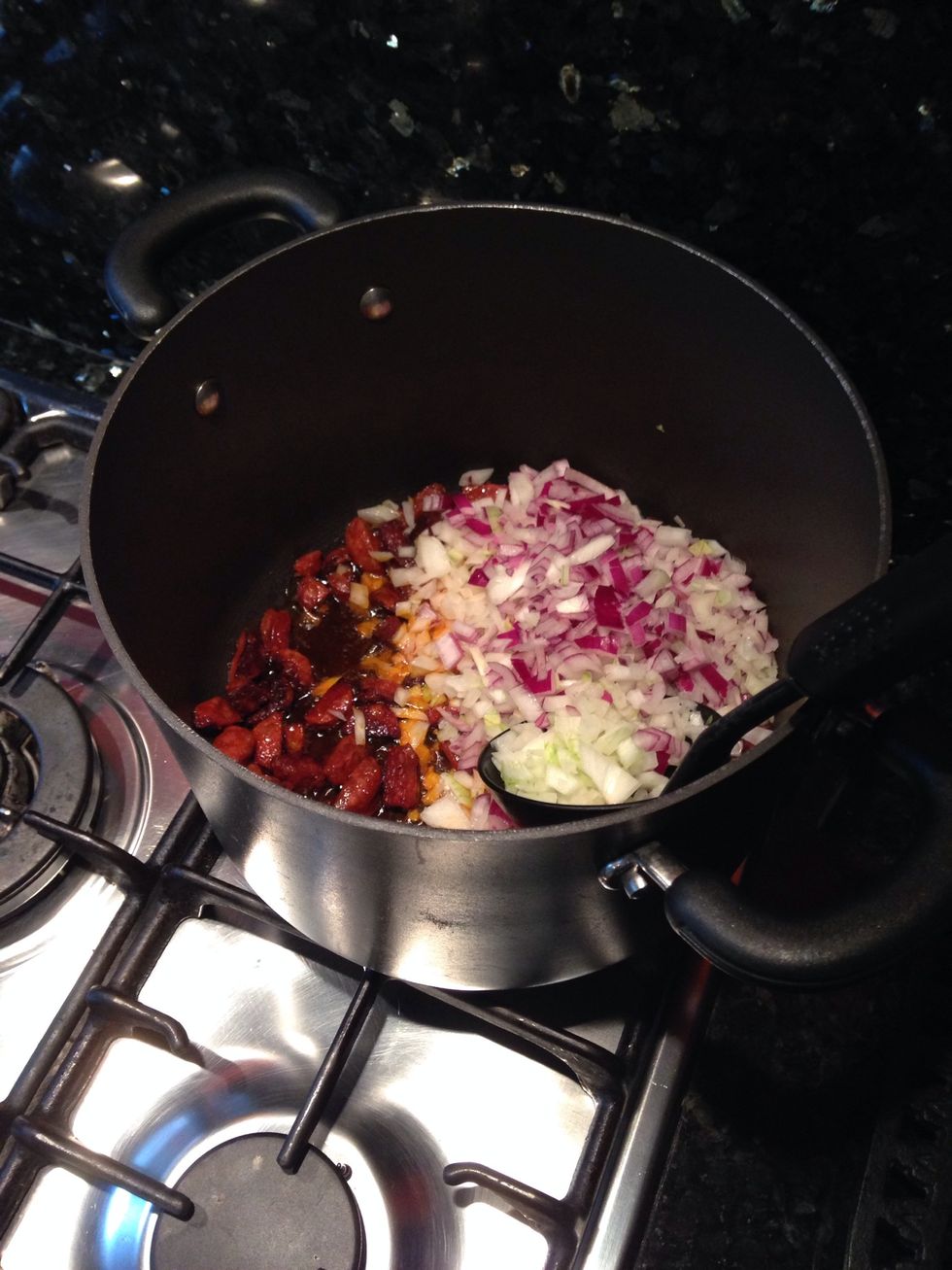 Turn down the heat then add the onions and crashed garlic