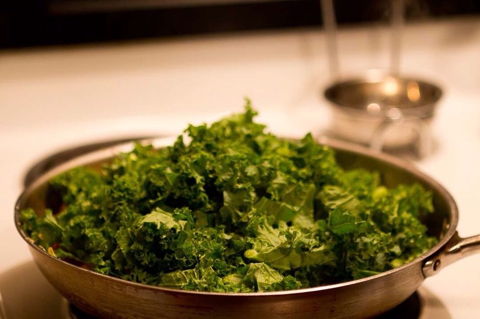 Turn down to a simmer and add the kale to the pan. Don't mix it just yet.