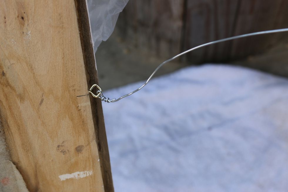 Turn frame around and screw in small picture hooks and wire. Use as many hooks and wires as you need for the size of frame you have. We used four hooks and two wires.