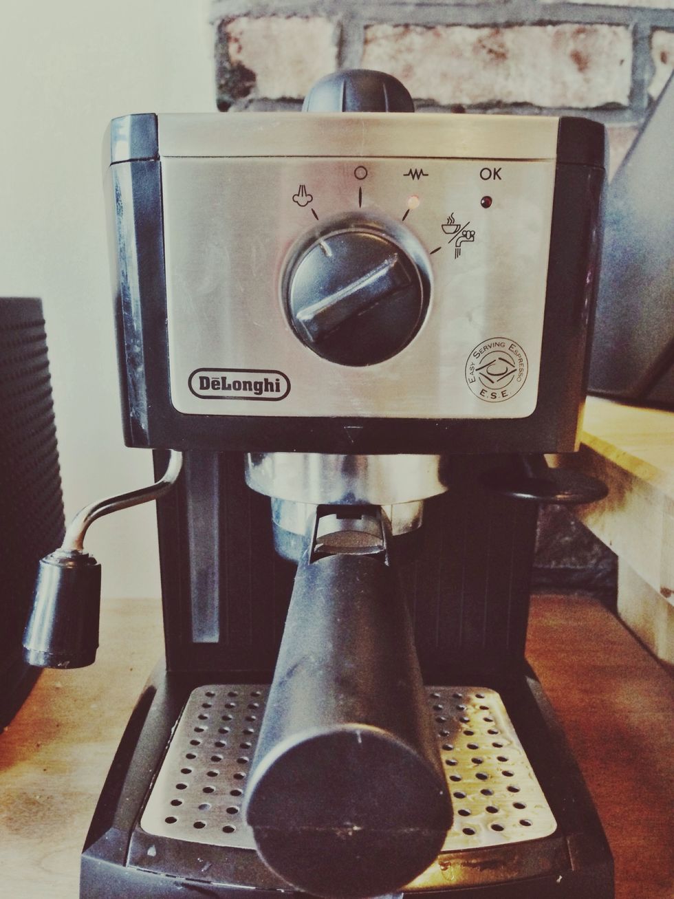 Turn front knob all the way to the left. This will start heating the water in order to steam the milk and extract the espresso. Make sure machine has enough water to steam milk and extract espresso.