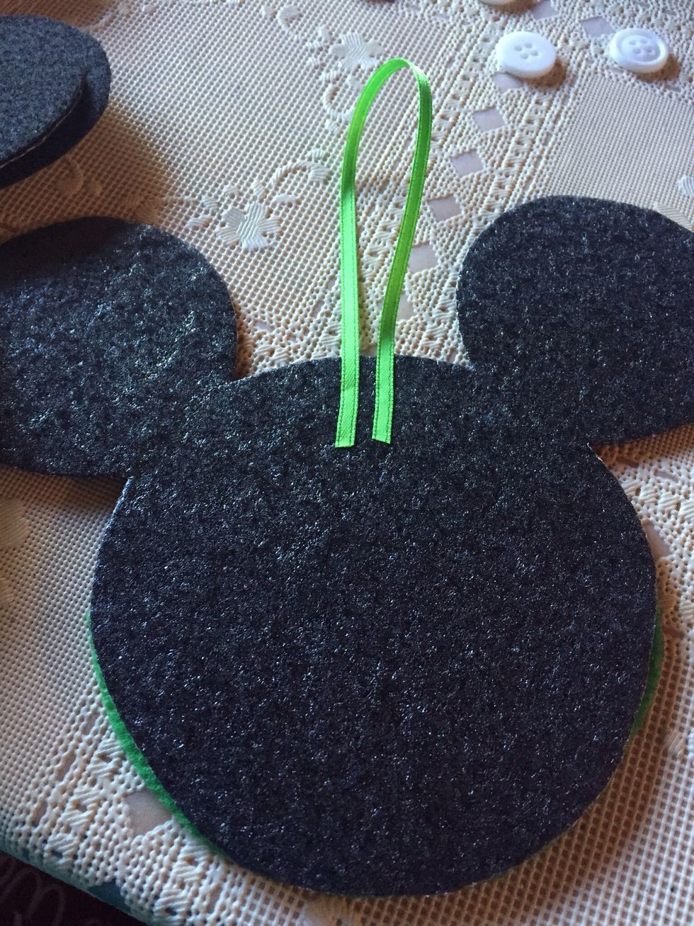 Turn head over and peel adhesive backing off of felt, and attach ribbon to be used to hang on tree.