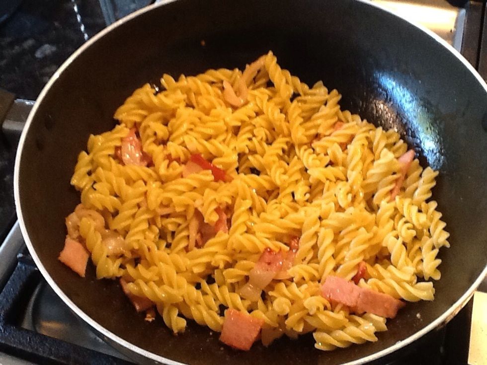 Turn heat to low and add the cooked pasta, mix together so the pasta can soak in the flavour of the bacon and chilli.