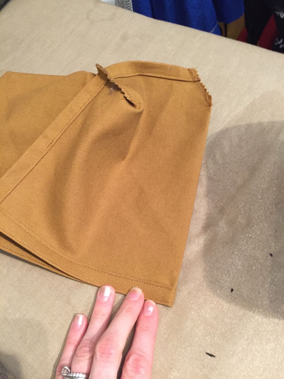 Turn inside out and press a seam from the center pleats up to the top part of the bottle holder.