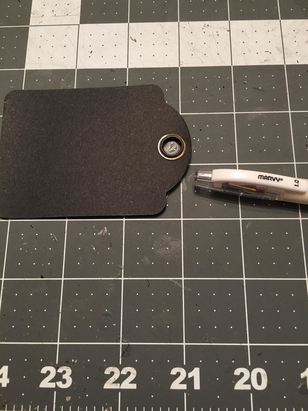 Turn it over and use a marker pen to mark the hole for the tag as shown.