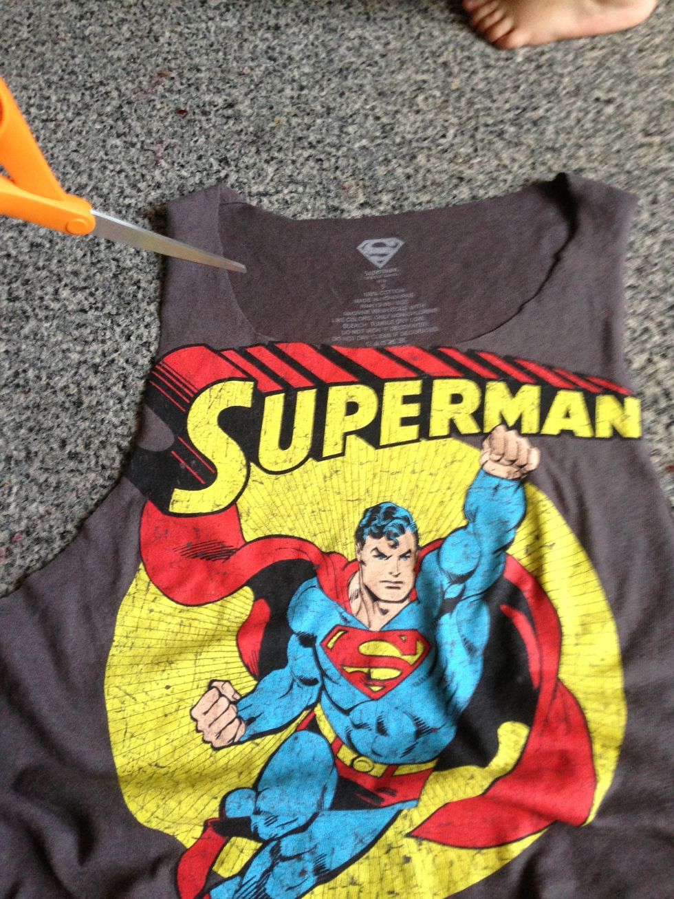 Turn it to the front and cut your shirt as low/high as you want it.