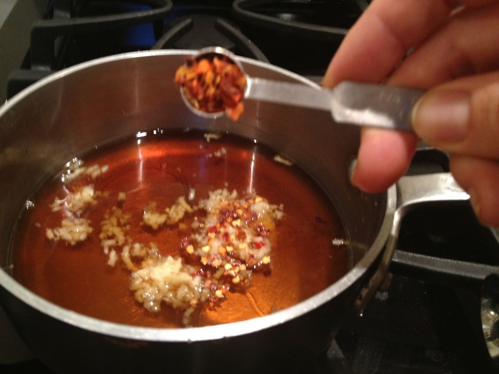 Turn off the heat and add 1/4 teaspoon red pepper flakes, 3 pressed garlic cloves, and 1 teaspoon toasted sesame oil. Remove from stove and let cool.