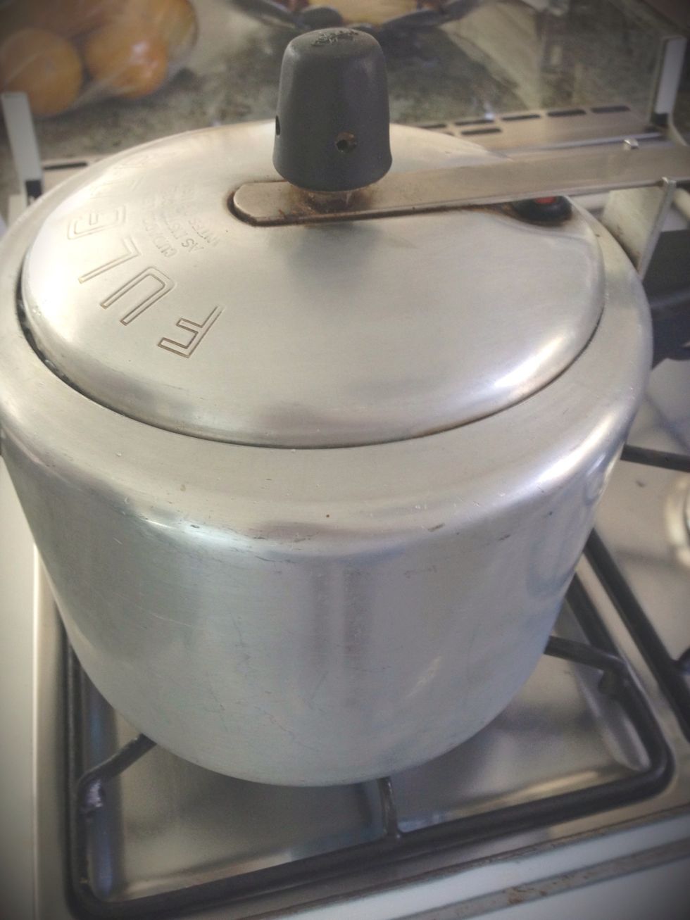 Turn on medium fire, and wait till the pressure cooker starts beebing, when it does count 15-20 minutes and then turn off the fire... And take out the can