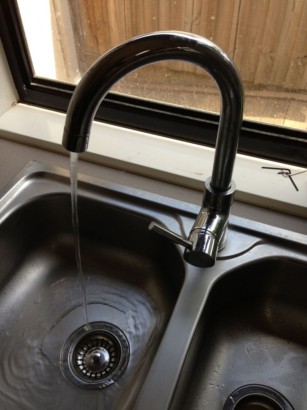 Turn on taps under the sink or basin and then  slowly turn on tap, there may be some air pressure that comes out first, then the water.