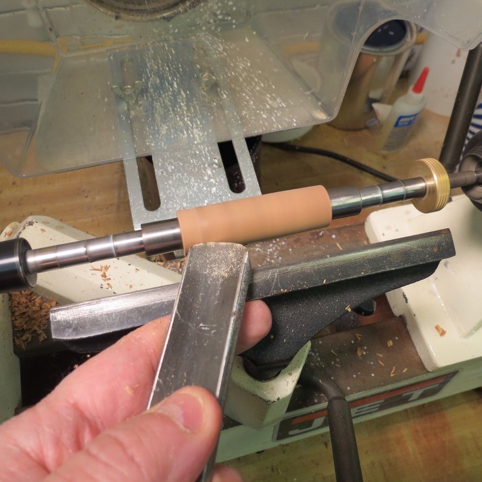 Turn on the lathe and begin shaping the blank. I like to use a gouge most of the time. Maintain a slow, light touch. DO NOT shave all the way down to the bushings with your cutting tool.