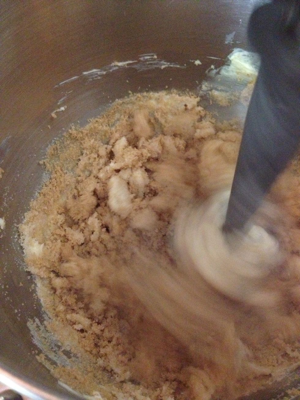 Turn on the mixer and blend the sugars with the butter.