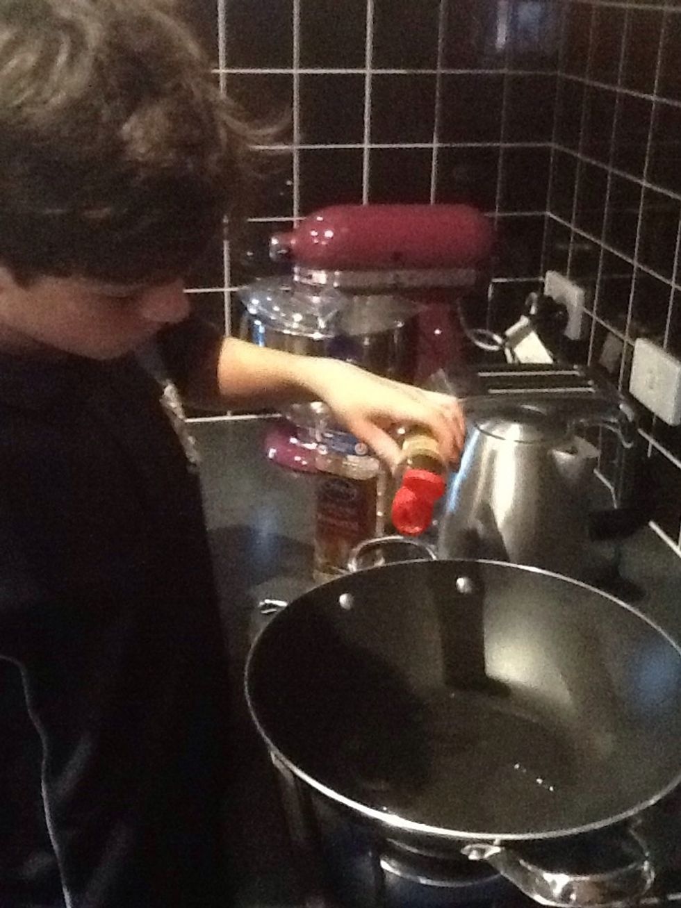 Turn on you oven top to medium heat and add the canola sesame and the sirachi oil