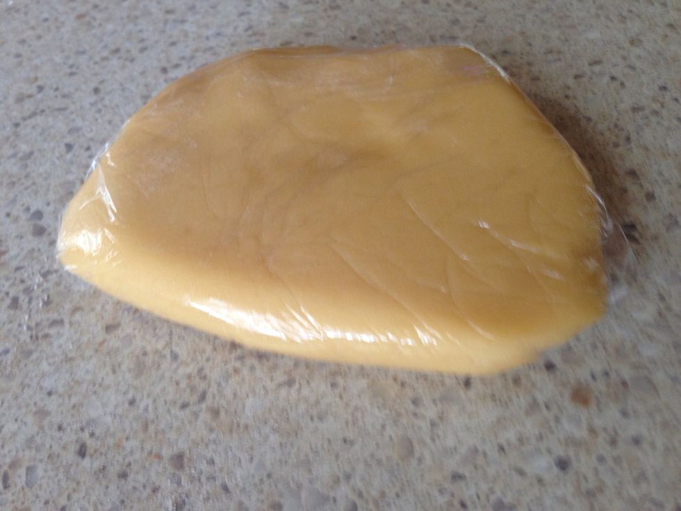 Turn onto a lightly floured surface and knead until smooth. Wrap one-third of the dough in plastic wrap. Wrap remaining dough in plastic wrap. Place both dough portions in the fridge for 30 minutes.