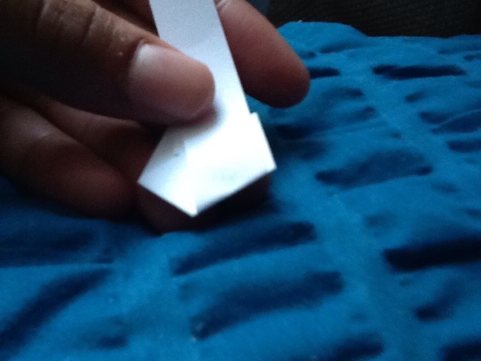 Turn over the paper and fold the long end around the pentagon