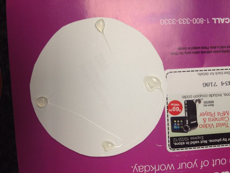 Turn over the photo and put hot glue dots all around the curves.