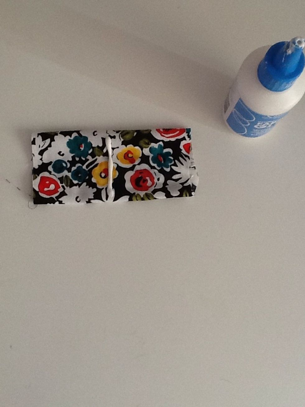 Turn over to the other side and put a line of glue down the middle.