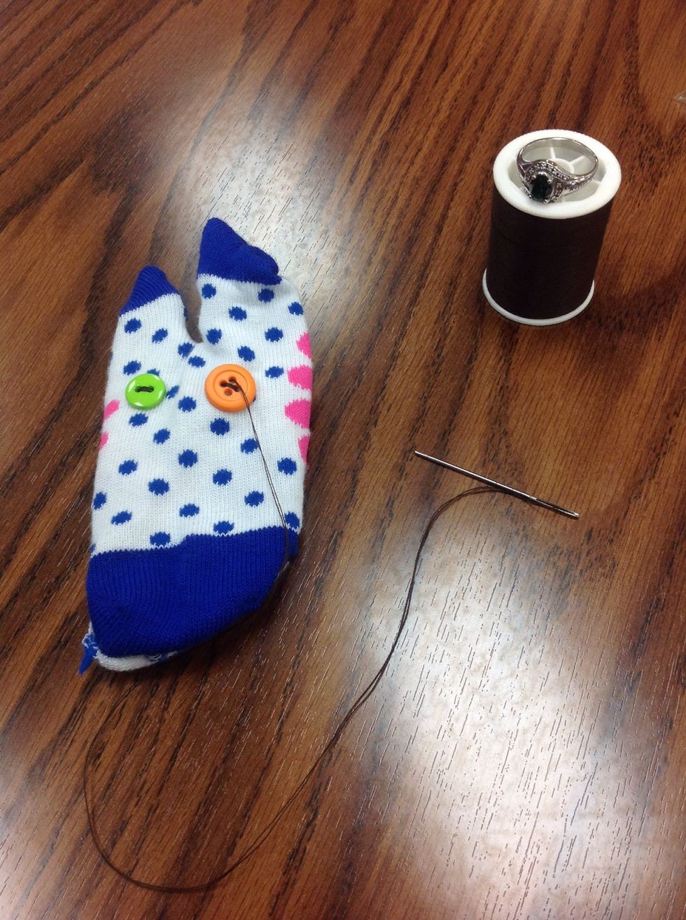 Turn sock back to the right side and sew the "eyes" on