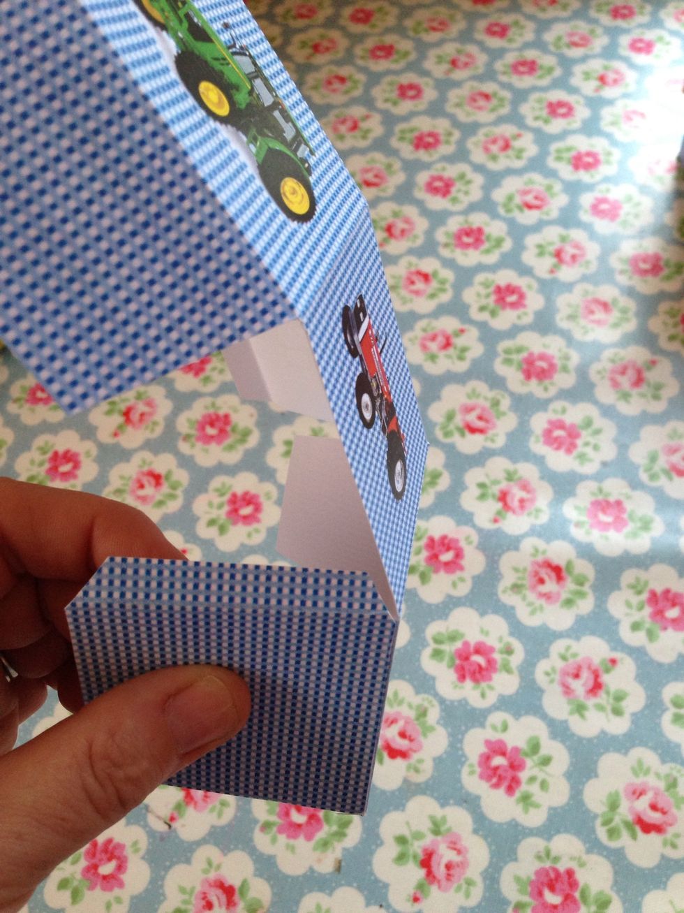 Turn the base and fold the next side onto the thin tab of the base and press to stick.