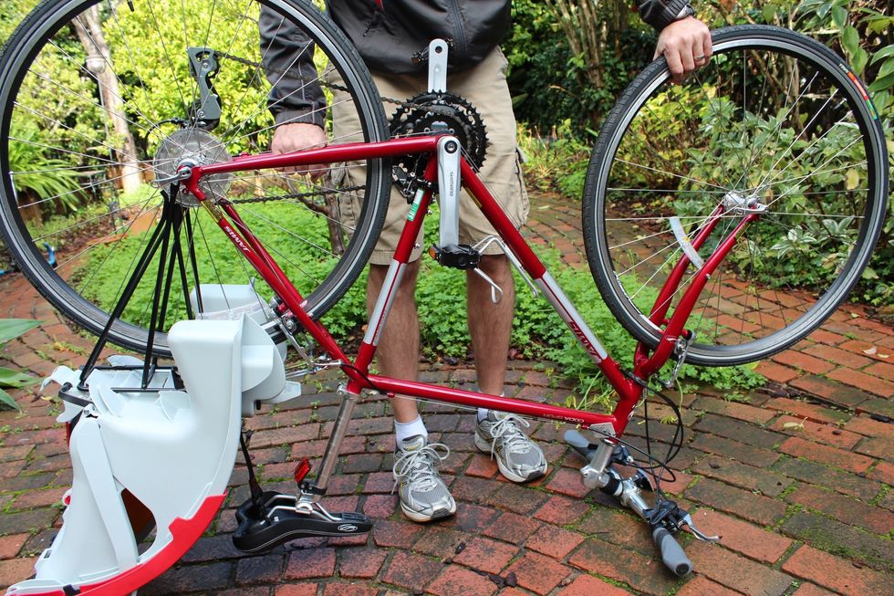 Turn the bike upside down, balancing the bike on the seat and handlebars.