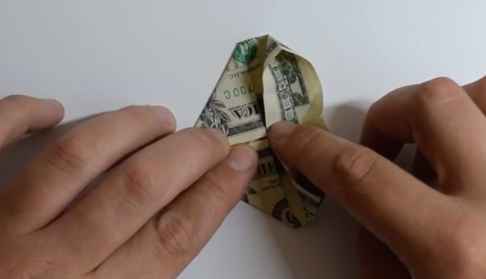 Turn the bill so that the folded corners are on the left. Fold the outside flap to the middle. Make sure not to get the other side
