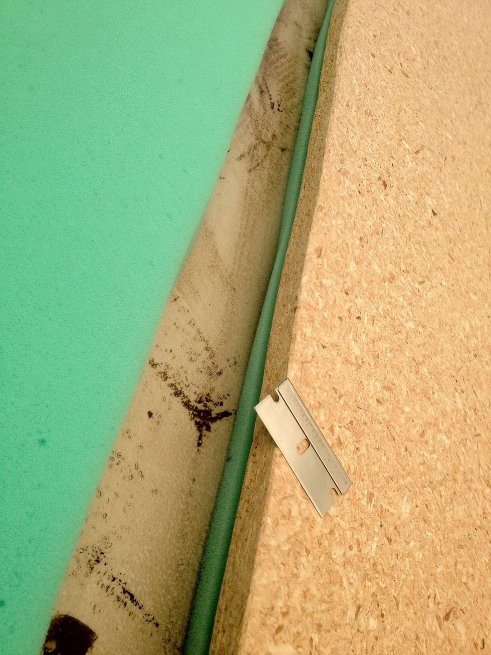 Turn the board foam-side down. Use a razor around the edges. To trim the foam to the board.