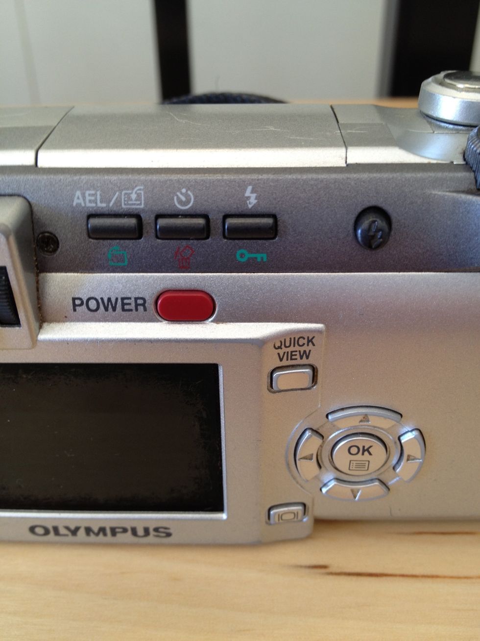 Turn the camera on by pressing the red POWER button. If you leave the camera alone too long it will turn off and you will need to press this again to wake it up! Don't forget to take off the lens cap