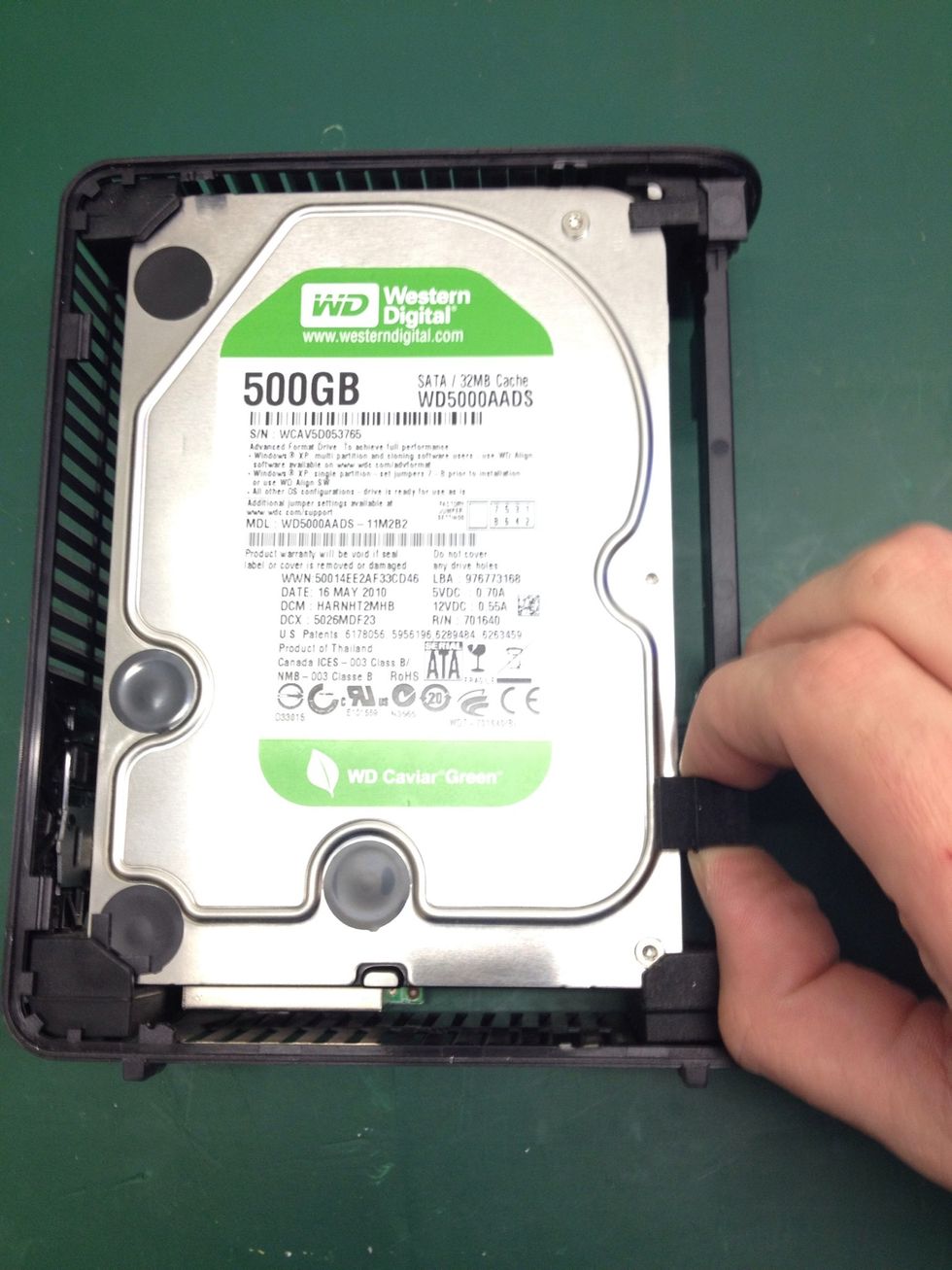 Turn the chassis back over and locate this piece of rubber, pull it up and away and...