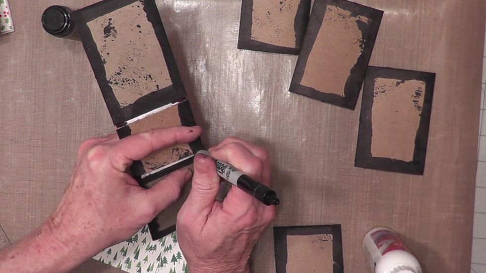 Turn the cover over and use a marker to color the top edges of the Tyvek on the inside as shown. Also color any cardboard tube areas or Tyvek showing that will not be covered with paper.