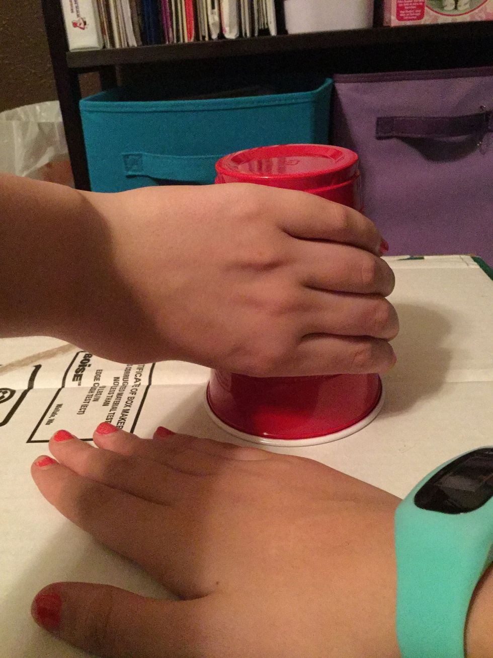 Turn the cup over on the surface, still with your right hand on the surface, so that they're crossed. And that's it!