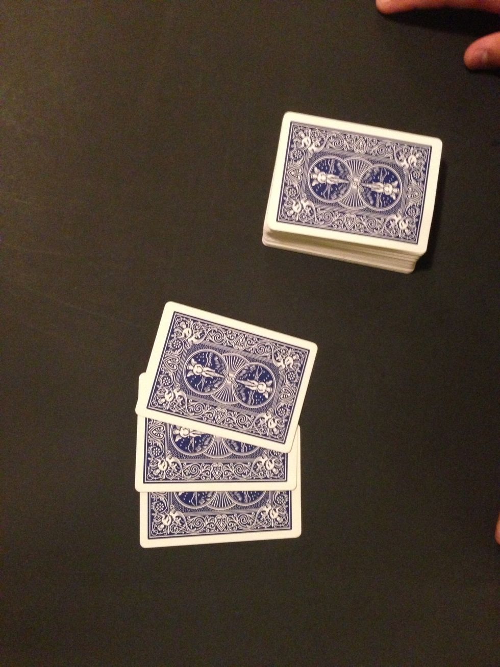 Turn the deck over again and ask if it is their card, they will say no. You take that card, then put it down, and repeat until you have three cards down and their card on the bottom.
