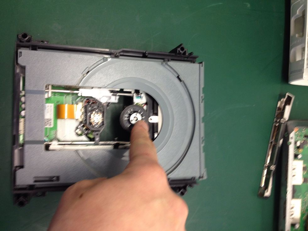 Turn the drive over again and gently push down as indicated in the photo. The drawer will move slightly.