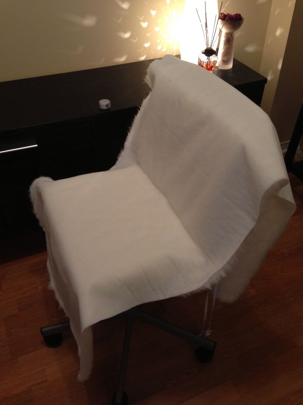 Turn the fabric upside down and pin it around the chair. Keep an opening in order to get it off the chair. It works with only sewing about 4" on the bottom fold.