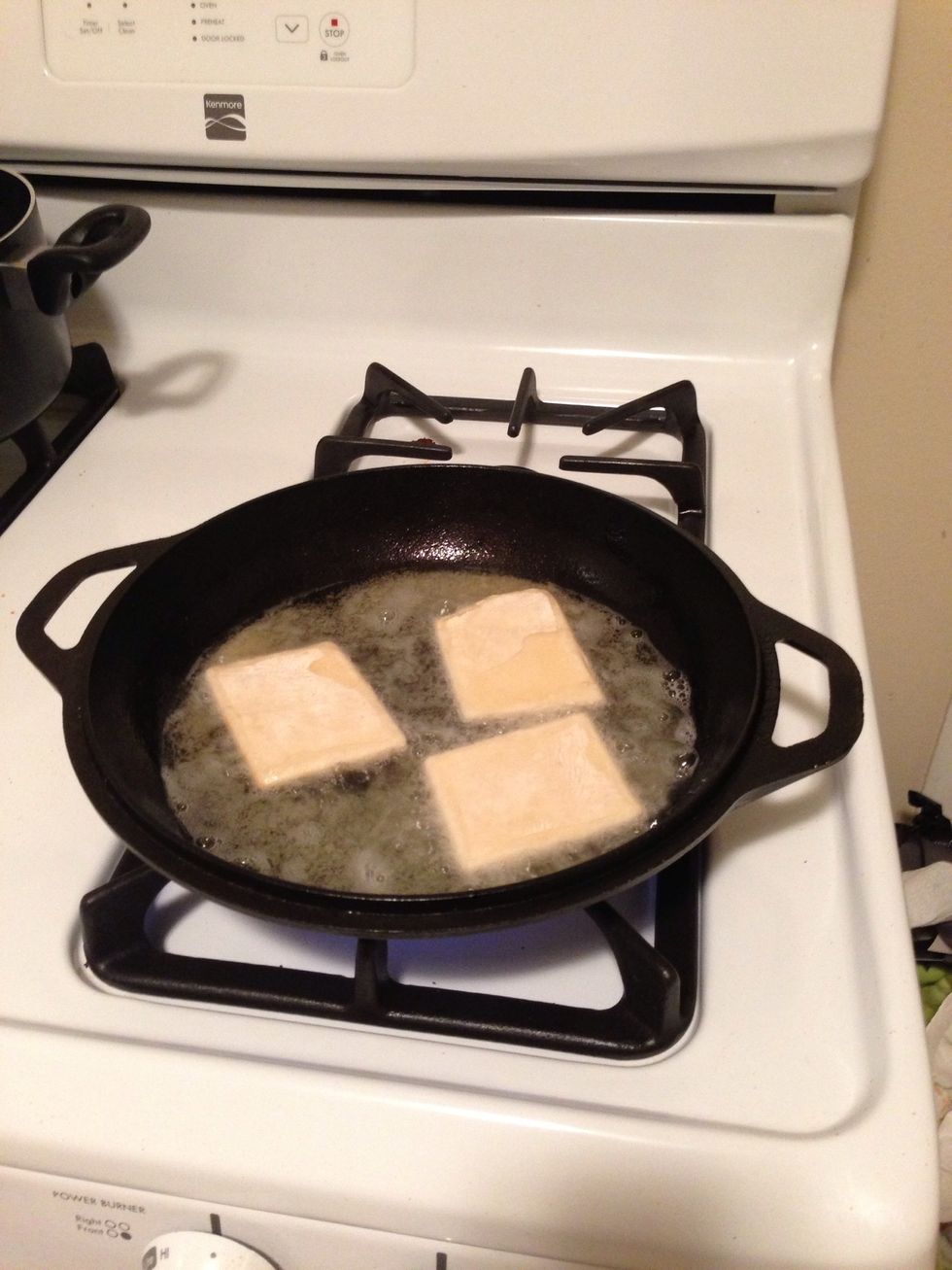 Turn the frying pan down to med heat and throw the sopapillas in the pan. The warmer the sopapillas are, the more they will puff.