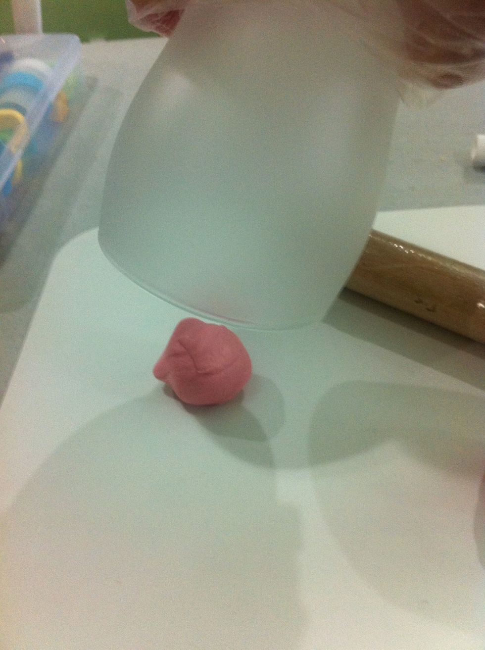 Turn the glass upsidedown and put the gum paste that you set aside while your doing the other half of the gum paste .