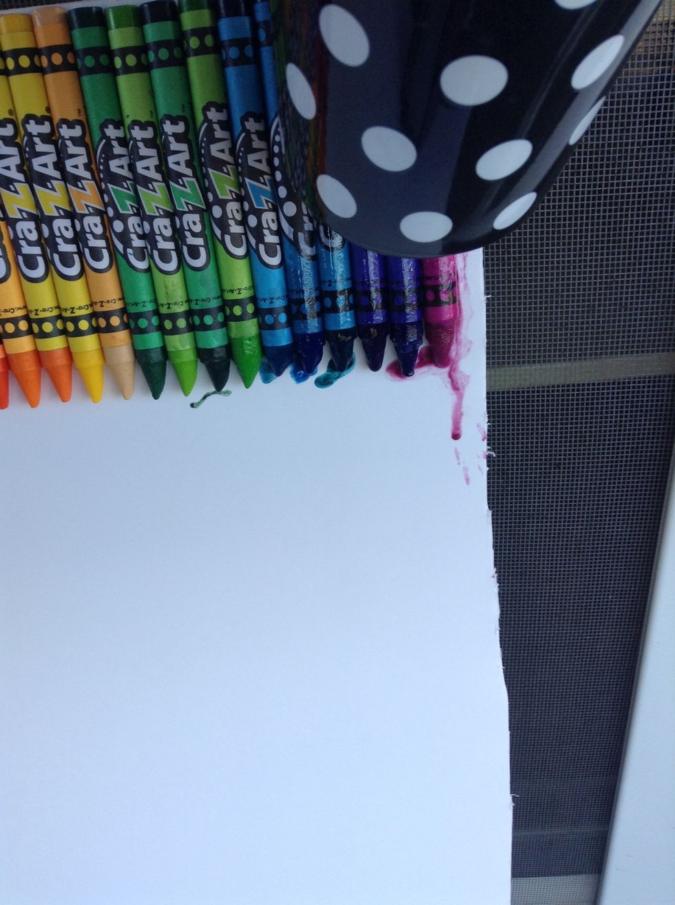 Turn the hair dryer on and put close to crayons. They will start to melt, but you must be patient.