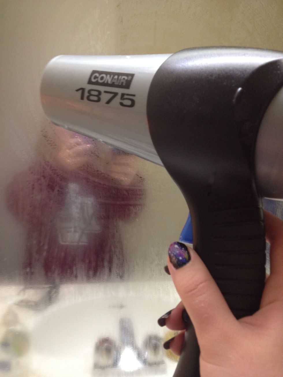 Turn the hair dryer on and put it on the high setting. Point it towards your mirror.