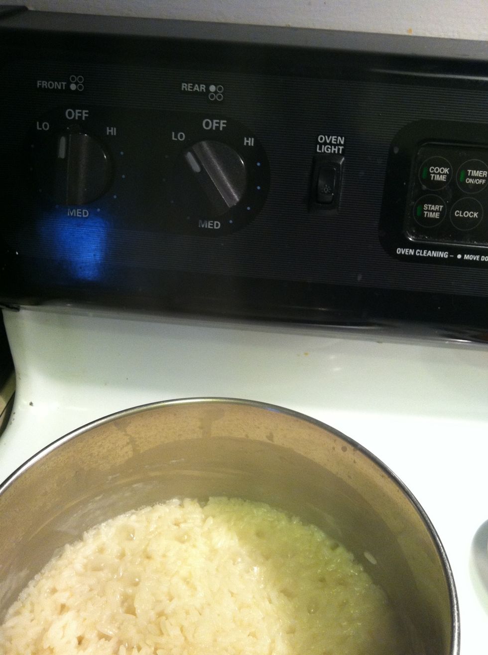Turn the heat down to low. And stir rice