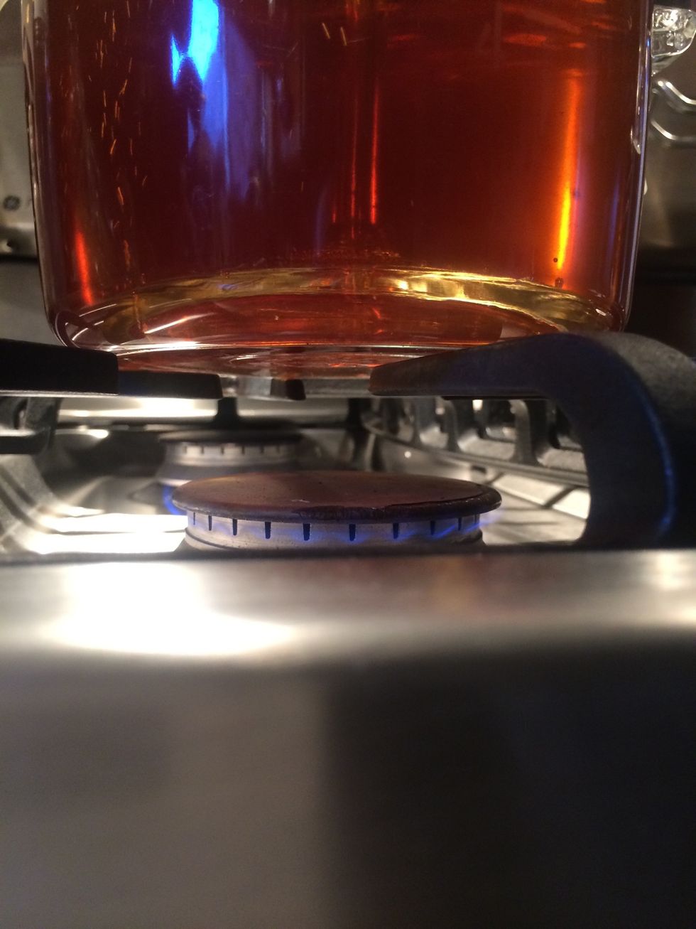 Turn the heat or the flame down to the lowest setting. Simmer. Make sure that coffee is still perking up through the tube and over the beans. Set a timer for 8 minutes.