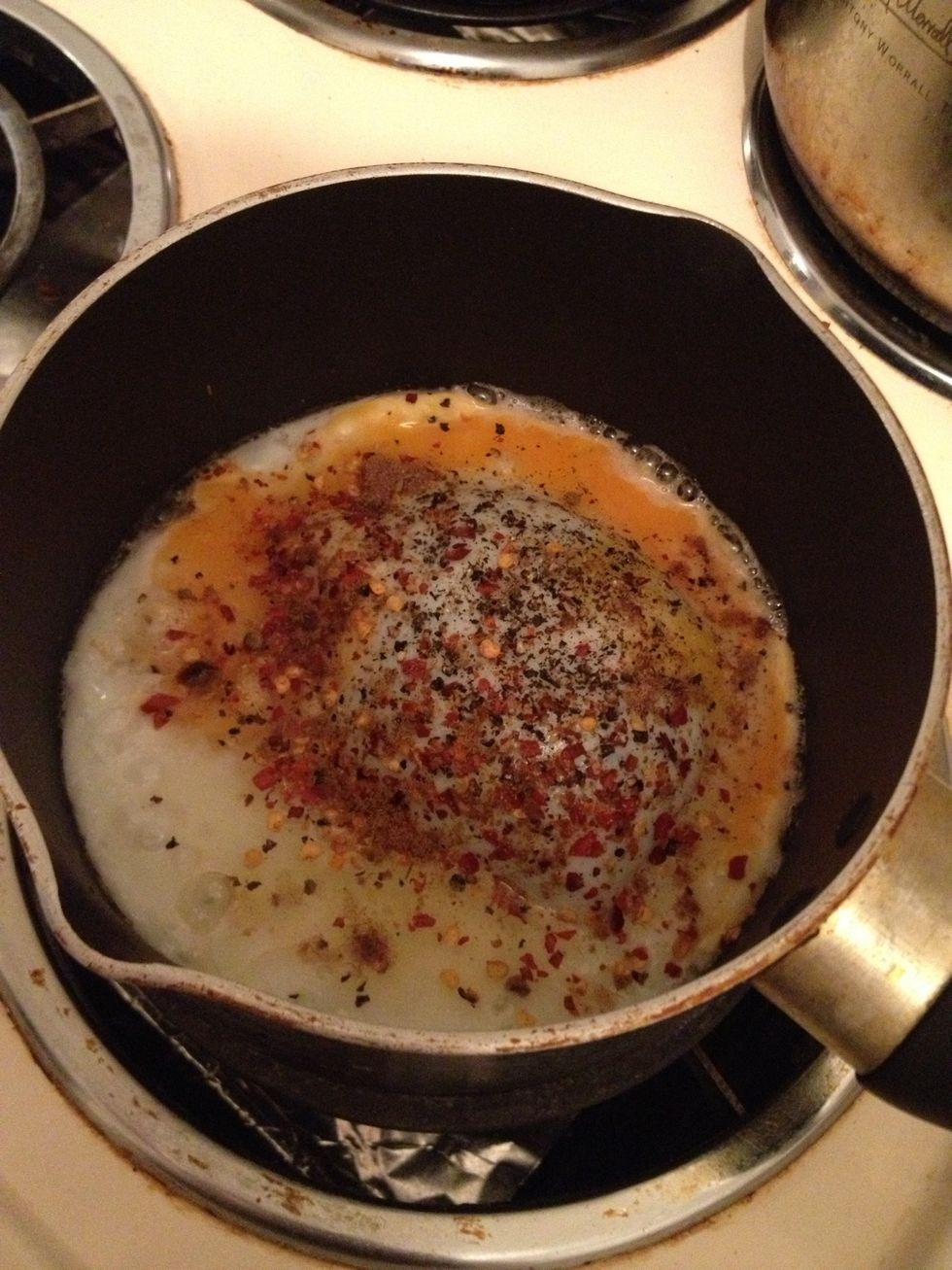 Turn the heat to medium, crack the eggs and add seasoning to your liking. Personally, i enjoy with plenty of pepper and chili flakes :)