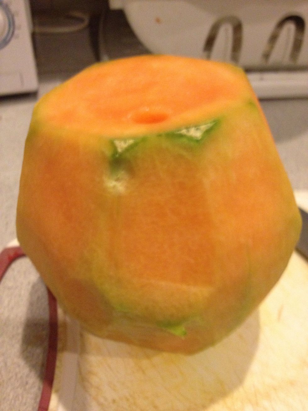 Turn the melon upside down and slice the remaining skin. Your melon should look like this.