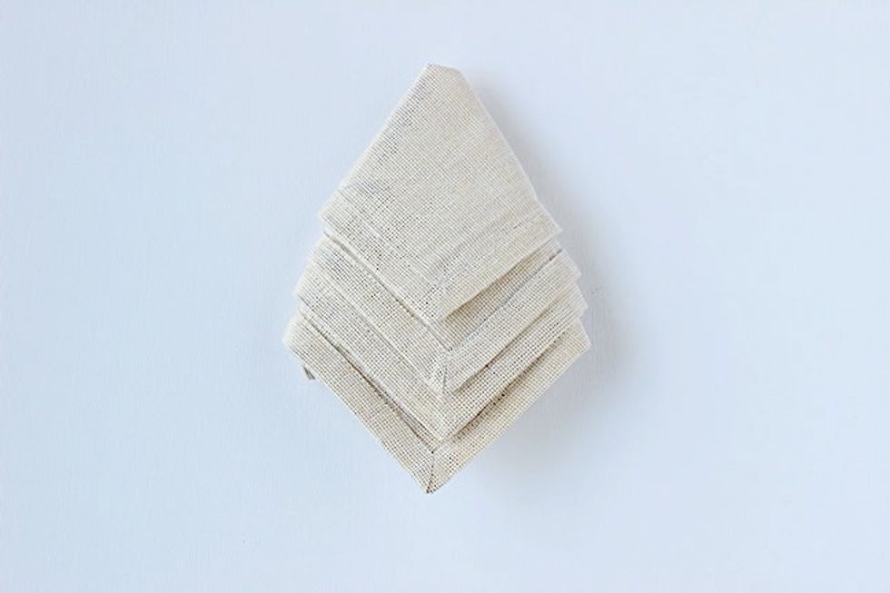 Turn the napkin over, make sure the layers point down towards you.