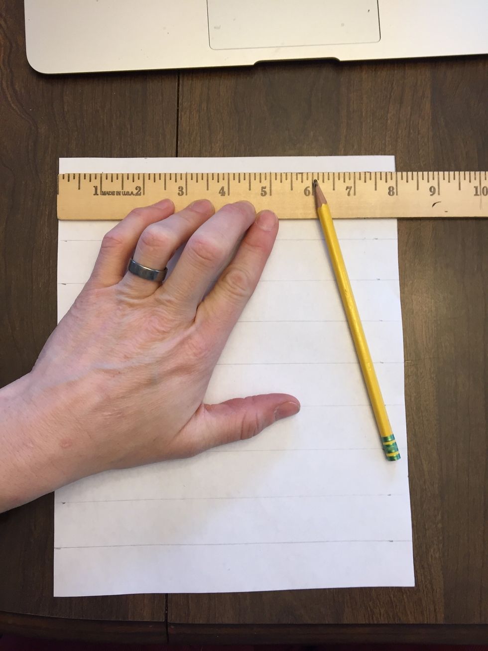 Turn the paper and line up the ruler along the short edge of the paper this time. Make 7 light marks across the top.