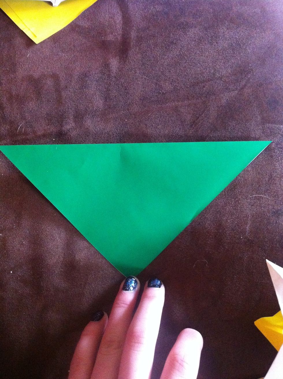 Turn the paper diagonally and fold down into a triangle